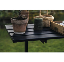 Gartentisch mit Blumentopf, Garnrolle und Holzkiste