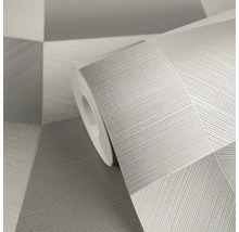 Graue Vliestapete auf Rolle mit geometrischem Muster und feiner Linienstruktur.