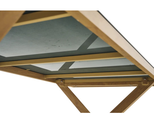 Detailansicht der Unterseite eines Holztisches mit Glasplatte und stabilisierender Rahmenkonstruktion.