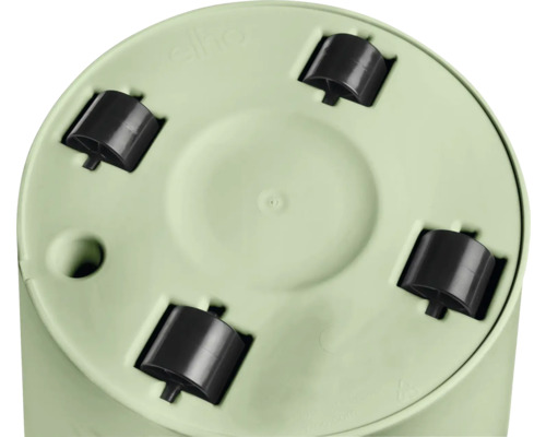 Unterseite eines runden, hellgrünen Blumentopfs mit vier schwarzen Kunststoffrollen und Entwässerungsloch.