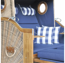 Strandkorb aus Holz und Geflecht mit blauen Polstern, karierten Kissen und Bullaugen.