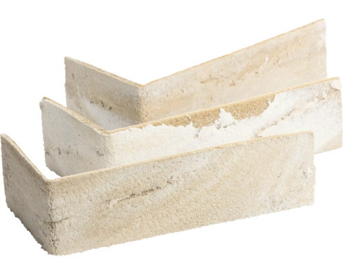 L-förmige beige Eckriemchen für Wandverkleidungen mit grober Steinoptik.