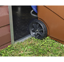 Biohort Kunststoffrad eines Rollsystems beim Überqueren einer Türschwelle am Gartenhaus über einer Rasenfläche.