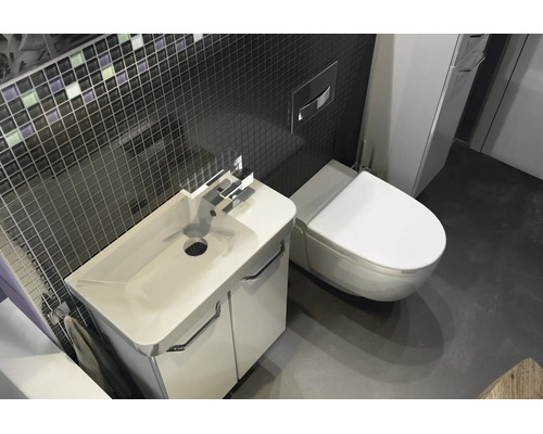 Modernes Badezimmer mit weißem Waschtischunterschrank, Keramikwaschbecken, wandhängendem WC und dunkler Mosaikfliesenwand.