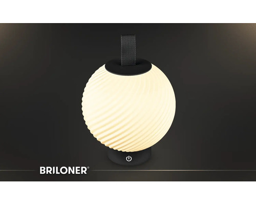 Tragbare Briloner LED-Tischleuchte, kugelförmig mit Spiralmuster, schwarzer Tragegriff und Sockel mit Ein-Aus-Symbol. Briloner Logo.