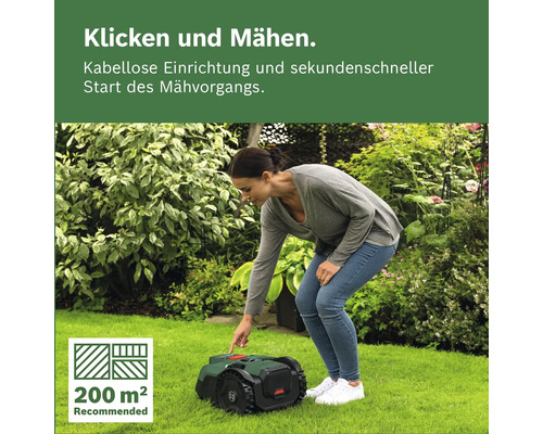 Eine Frau startet einen Mähroboter auf einer Rasenfläche in einem hellen, bepflanzten Garten. Empfohlen für bis zu 200 Quadratmeter.