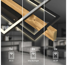 LED-Deckenleuchte aus Holz und schwarzem Metall mit drei Schaltstufen für Hauptlicht und Hintergrundbeleuchtung.