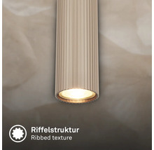 Zylindrische Leuchte mit Riffelstruktur und Licht.