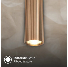 Detailansicht einer zylindrischen Leuchte mit Riffelstruktur.
