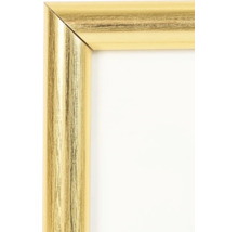 Nahaufnahme einer Bilderrahmen-Ecke in Gold mit strukturierter Oberfläche.
