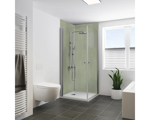 Modernes Badezimmer mit Eckduschkabine, Regendusche und Wandpaneelen in Betonoptik, daneben wandhängendes WC und Handtuchheizkörper.