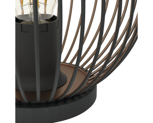 Nahaufnahme einer Tischleuchte im Industriedesign mit einem Metallkäfig aus schwarzen und bronzefarbenen Streben sowie einer E27 Fassung.