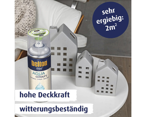 Belton Free Aqua Colours Sprühlack mit hoher Deckkraft und Witterungsbeständigkeit neben dekorativen Häusern auf einem runden Tisch