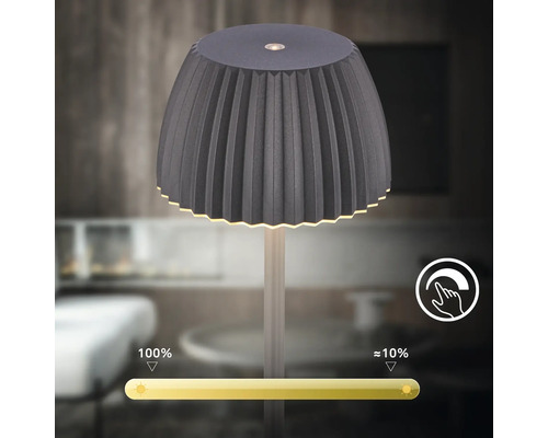 Tischleuchte mit plissiertem Schirm und integrierter Touch Dimmer Funktion fuer stufenlose Helligkeitsregulierung.
