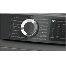 Bedienfeld eines Waschtrockners mit Drehknopf zur Programmauswahl und digitalen Display für Wasch und Trockenoptionen.