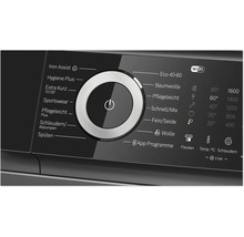 Bedienblende einer Waschmaschine mit Programmwähler und digitalem Display zur Einstellung von Waschprogrammen und Temperaturen.