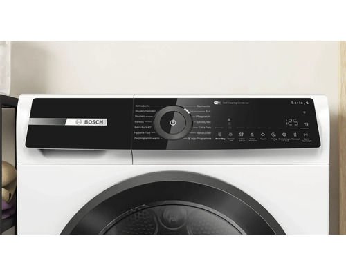 Bedienblende eines Bosch Serie 6 Trockners mit digitaler Anzeige, Drehwahlschalter und verschiedenen Programmsymbolen.