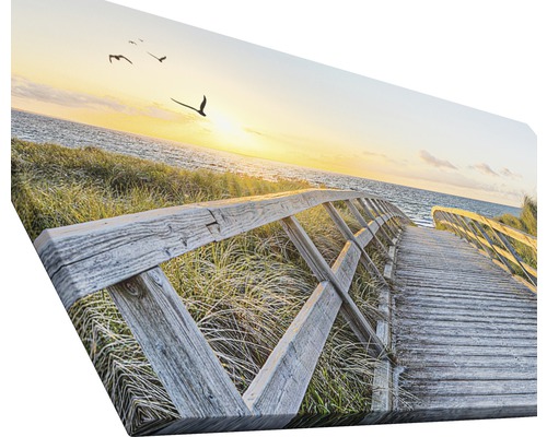 Leinwanddruck mit einem Holzsteg zum Meer bei Sonnenuntergang