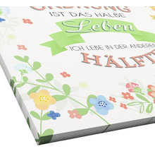 Leinwandbild mit Blumenmuster und deutschem Spruch über Ordnung