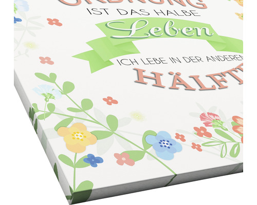 Leinwandbild mit Blumenmuster und deutschem Spruch über Ordnung