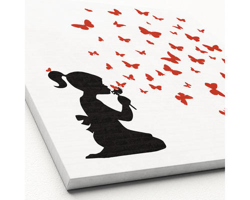 Leinwandbild mit Silhouette eines Mädchens, das eine Blume küsst und von Schmetterlingen umgeben ist