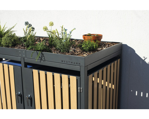 Mülltonnenbox mit Bepflanzung auf dem Dach und Westmann Logo.