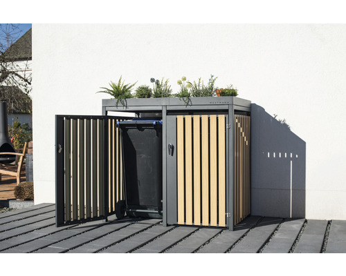 Mülltonnenbox mit Pflanzen auf dem Dach und einer Mülltonne