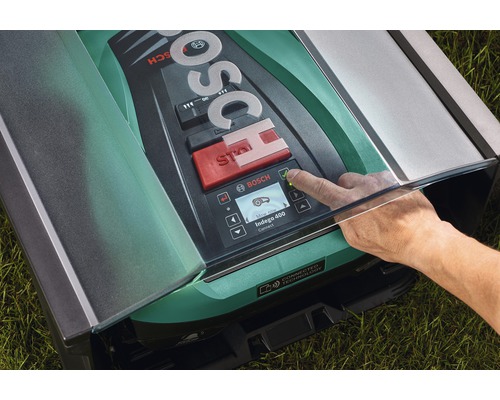 Bosch Logo auf einem Mähroboter mit Hand, die einen Knopf drückt