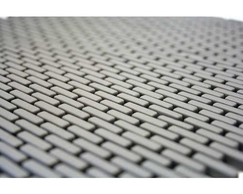 Detailaufnahme einer grauen Gummimatte mit rechteckigem Muster.