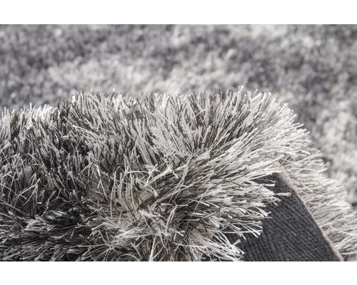 Detailansicht eines grauen Shaggy-Teppichs mit langen Fasern