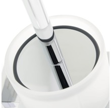 Blick in einen WC-Bürstenhalter aus Glas mit einem Griff aus Metall.