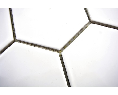 Nahaufnahme von weißen, hexagonalen Fliesen mit Fugenmasse