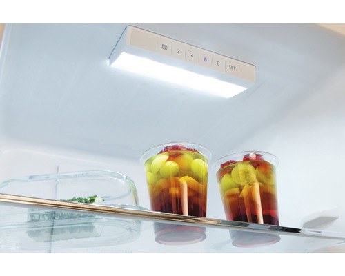 Innenansicht eines Kühlschranks mit LED-Beleuchtung und Lebensmitteln