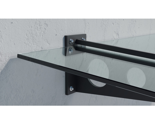 Glasvordach mit Metallhalterung an einer Wand