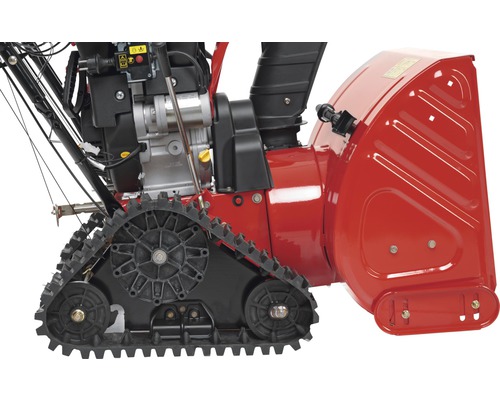 Detailansicht einer Schneefräse mit Raupenantrieb.