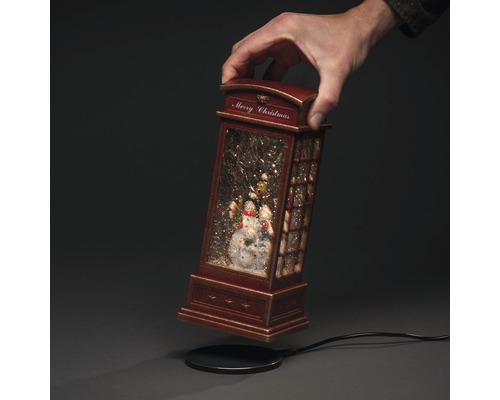 Dekorative Schneekugel in Form einer Telefonzelle mit Schneemann-Motiv und Merry Christmas Schriftzug
