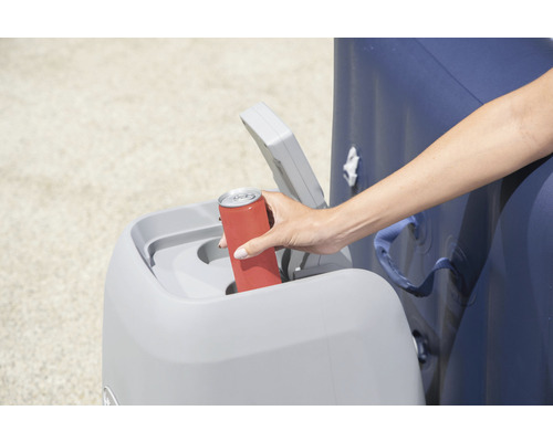 Eine Person wirft eine Getränkedose in einen Abfallbehälter aus Kunststoff.