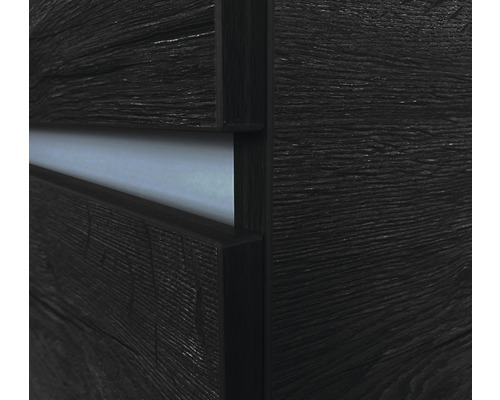 Detailaufnahme eines dunklen Holzmöbelstücks mit Schublade