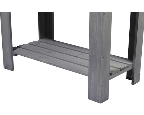 Detailaufnahme eines grauen Holztisches mit Ablage