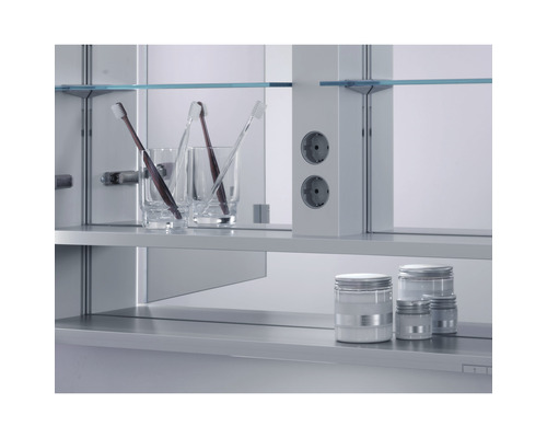 Badezimmerszene mit Spiegelschrank, Steckdosen, Zahnbürsten und Aufbewahrungsbehältern