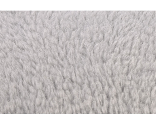 Nahaufnahme eines flauschigen, hellen Fleece Stoffes.