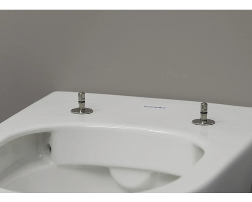 Detailansicht einer weißen Duravit Toilette mit Befestigungsbolzen