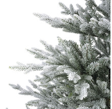Detailaufnahme eines künstlichen, schneebedeckten Weihnachtsbaums.