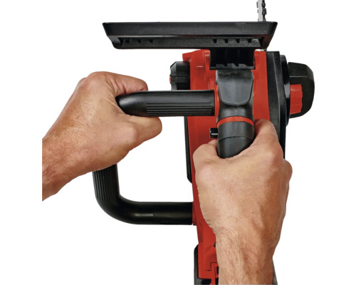 Eine Person hält eine Kettensäge mit zwei Händen.