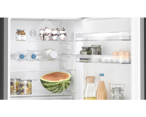Innenansicht eines Kühlschranks gefüllt mit Lebensmitteln wie Wassermelone, Getränken und Eiern