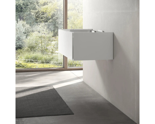 Waschtischunterschrank an der Wand im Badezimmer mit Fenster und Teppich