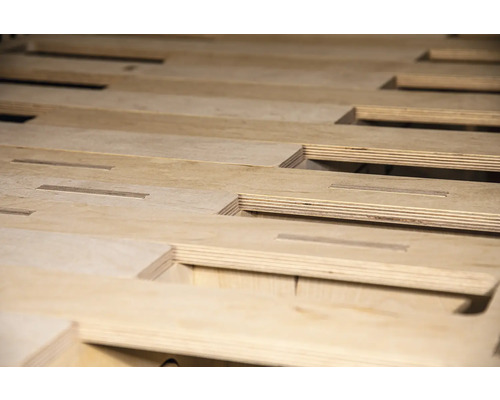 Nahaufnahme von Holzplatten mit Aussparungen für ein Holzkonstruktion.