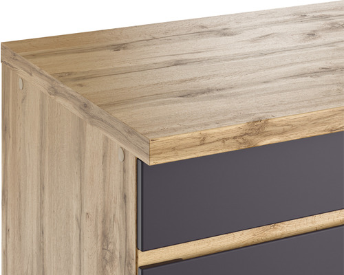 Detailansicht eines Schranks mit Holzoberfläche und dunklen Schubladen