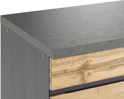 Detailansicht eines Badezimmerschranks mit Schubladen und einer Oberfläche in Betonoptik