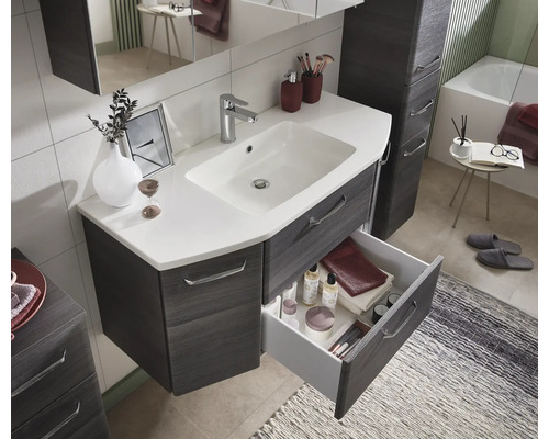 Badezimmer Szene mit Waschtischunterschrank, offenem Schubfach, Waschtisch, Armatur und Badaccessoires.